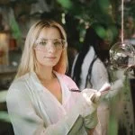 woman in white robe holding smartphone